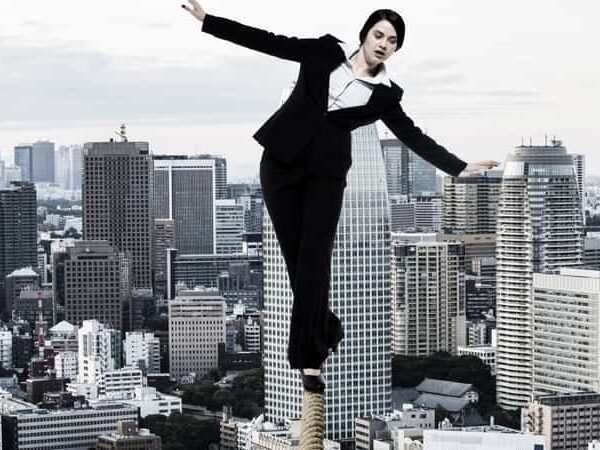woman on tightrope over city
