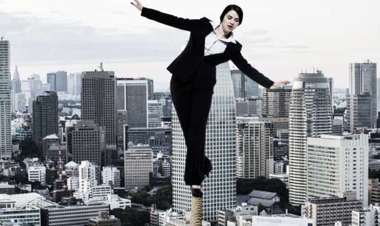 woman on tightrope over city